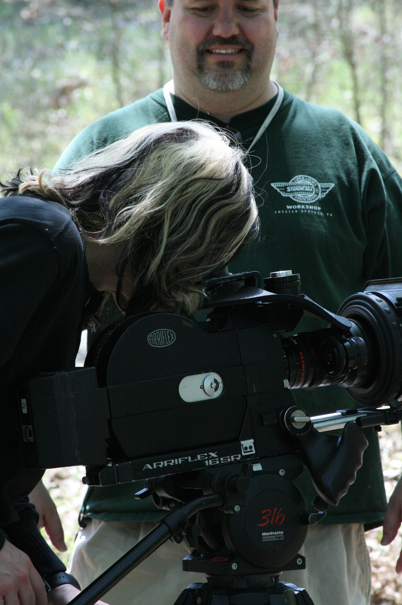 Cinematographer looks on as J.A Steel checks the shot on the Arri Super 16mm Camera for DENIZEN.