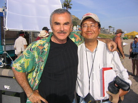 Burt Reynolds and Michael Goi, ASC on the set of the comedy 