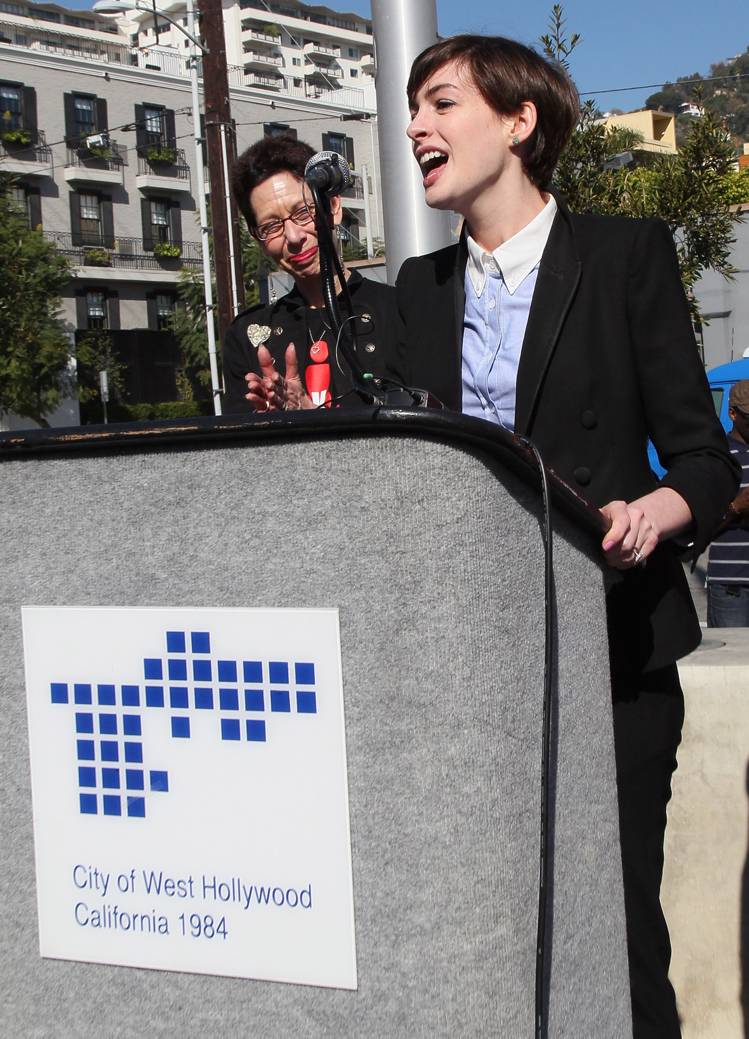Anne Hathaway (R) and City of West Hollywood Mayor Pro Tempore Abbe Land attend the kick-off for One Billion Rising in West Hollywood on February 14, 2013 in West Hollywood, California.