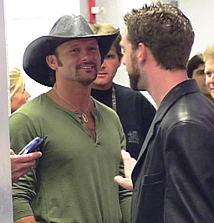 Brent Roske directs singer Tim McGraw backstage at the Staples Center for the NBC music special 'Superstar'. Faith Hill, also in the program, can be seen in the background.