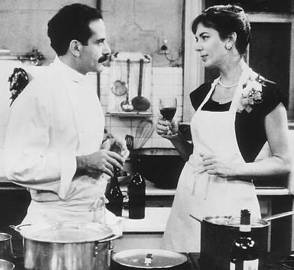 Tony Shalhoub (left) offers Allison Janney a sample of one of his culinary delights.