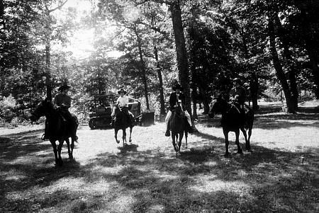 The Beatles (Paul McCartney, George Harrison, John Lennon, & Ringo Starr on horseback into the woods) in Ozarks, Arkansas. c. 1965