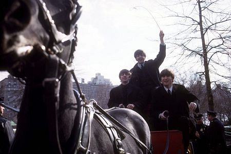 The Beatles ( Ringo Starr, Paul McCartney, John Lennon on a horse carriage ride, Paul the only one standing)