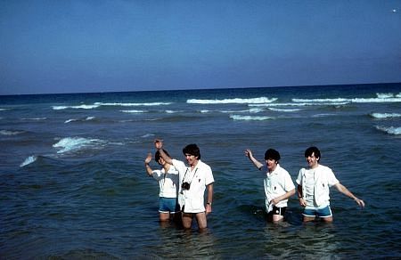 The Beatles ( Ringo Starr, George Harrison, John Lennon, Paul McCartney wades in the water)