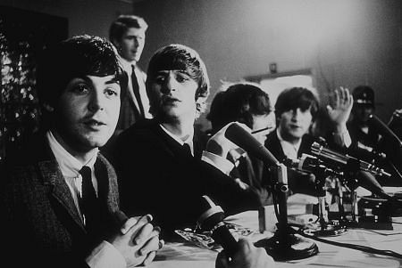 The Beatles ( Paul McCartney,Ringo Starr, George Harrison, John Lennon) at a press conference. c. 1964