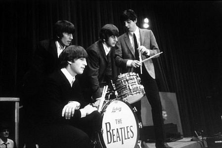 The Beatles (George Harrison, John Lennon, Ringo Starr, and Paul McCartney) on stage. c. 1964