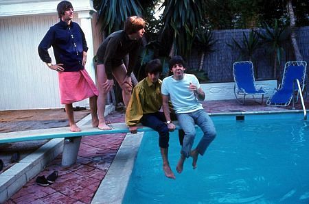 The Beatles (Ringo Starr, John Lennon, George Harrison, Paul McCartney), on the diving board by the poolside,
