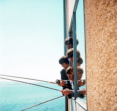 The Beatles ( George Harrison, Paul McCartney, Ringo Starr, John Lennon) fishing through a window, 1964