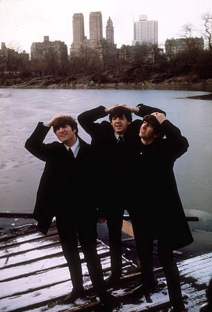 The Beatles (John Lennon, Paul McCartney, Ringo Starr with their hands on top of their heads and the city as their background., 1964