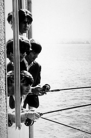The Beatles ( Paul McCartney, John Lennon, George Harrison, Ringo Starr) fishing outside a window in Seattle, Wa., 1964