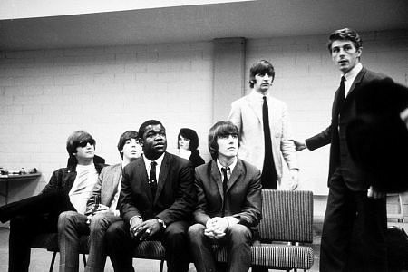 The Beatles (John Lennon, Paul McCartney, George Harrison, and Ringo Starr waiting for some instruction of some sort.) c.1964