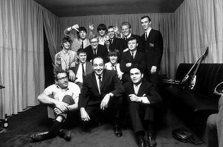 The Beatles (Ringo Starr, Paul McCartney, John Lennon, and George Harrison in a group picture with Management) c. 1964