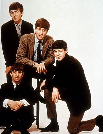 The Beatles, with John Lennon on the stool surrounded by the rest of the group,