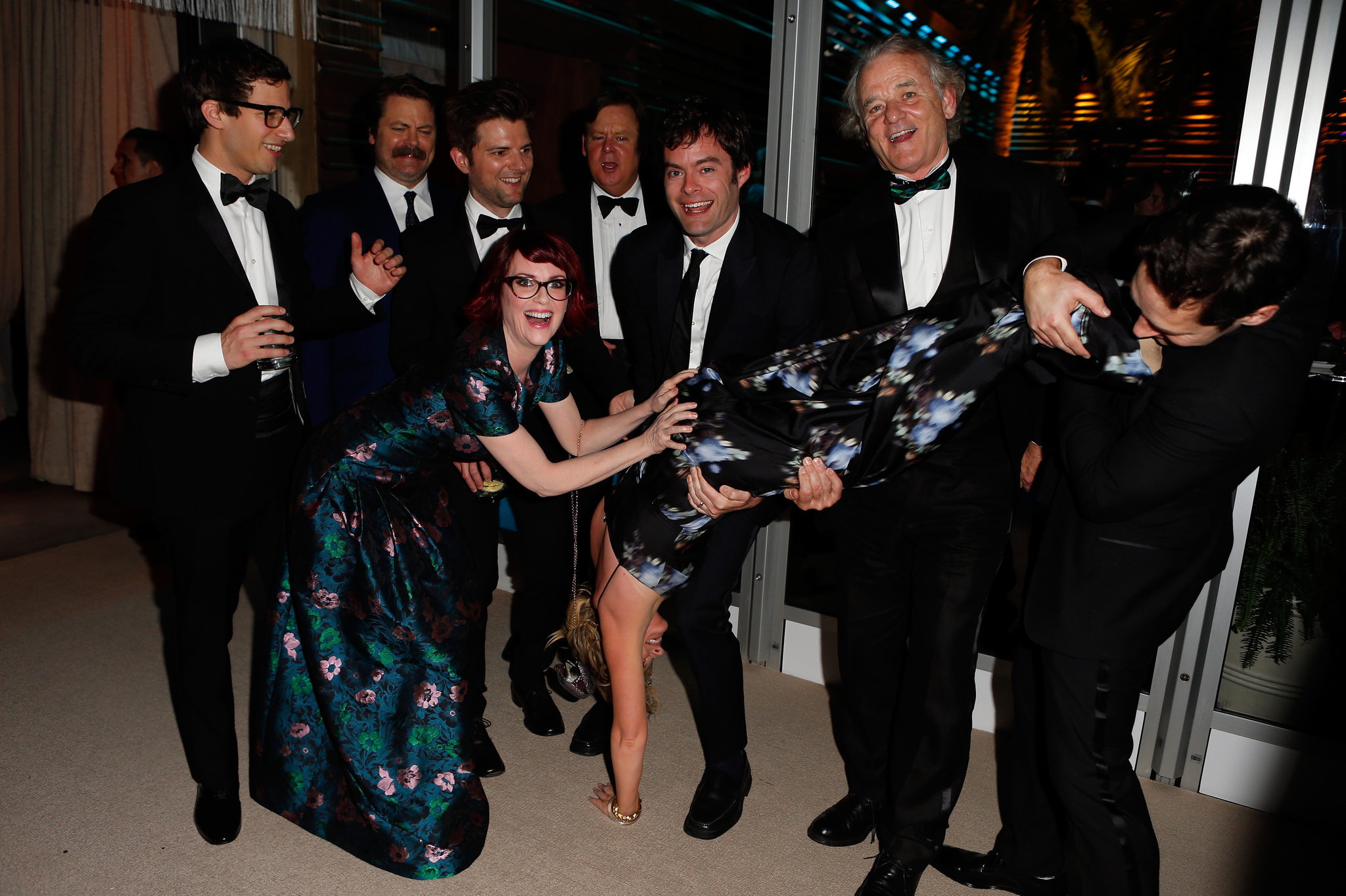 Andy Samberg, Nick Offerman, Adam Scott, Megan Mullally, Brian Doyle Murray, Bill Hader, Amy Poehler (performing handstand), Bill Murray, and Paul Rudd attend the 2014 Vanity Fair Oscar Party Hosted By Graydon Carter on March 2, 2014 in West Hollywood, California.