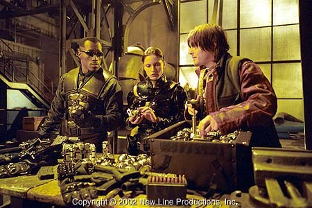 Blade (Wesley Snipes, left), Nyssa (Leonor Varela, center) and Scud (Norman Reedus) review their new weapons in New Line Cinema's action thriller, BLADE II.