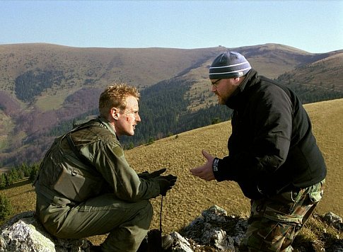 On location in Slovakia, OWEN WILSON (left) confers with director JOHN MOORE on the set of BEHIND ENEMY LINES.