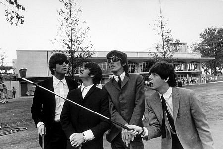 The Beatles (John Lennon, Ringo Starr, George Harrison, & Paul McCartney in Indianapolis. Paul points with a golf club)