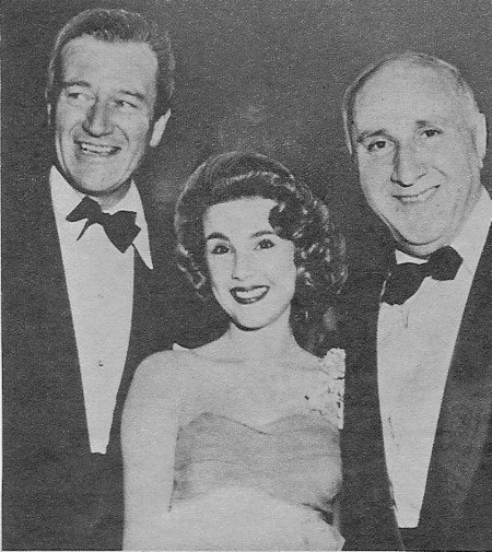 Stars John Wayne, Karen Sharpe, and composer Dimitri Tiomkin celebrate the premiere of 