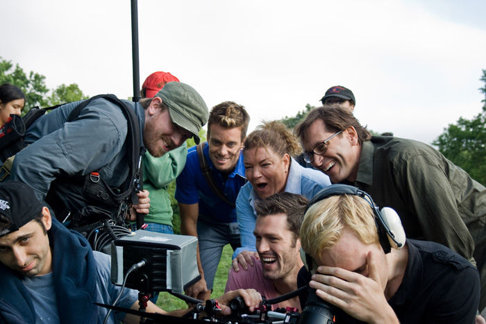 Director Casper Andreas watching the playback of a scene together with cast and crew on the set of 