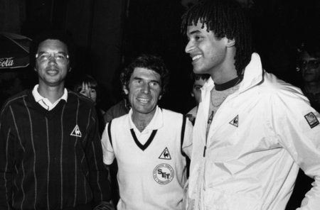 Arthur Ashe and Yannick Noah support Adrian Stonebridge during the 1982 Davis Cup in Grenoble, France - showing that Tennis Does Count!