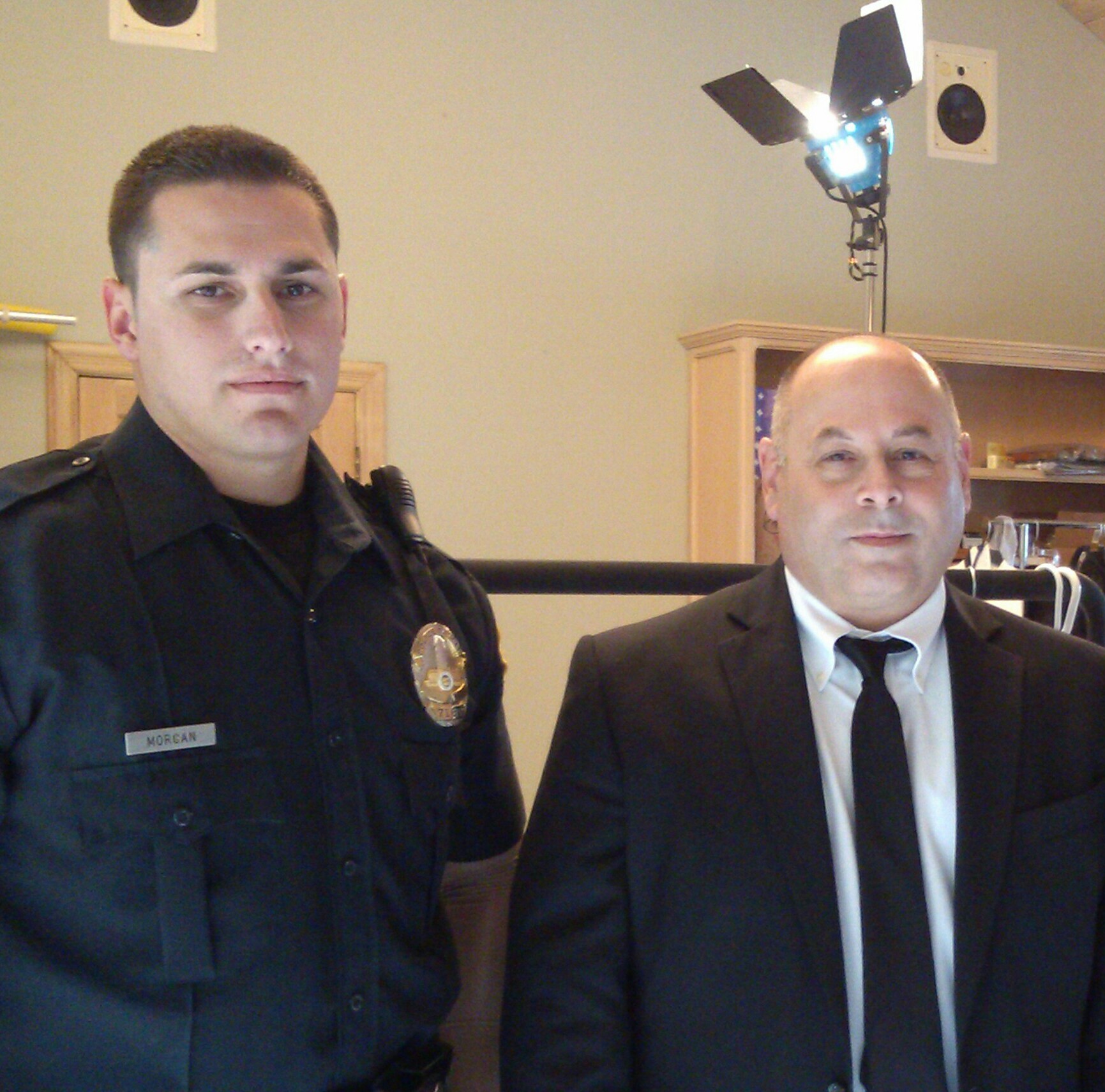 Dave Bean and real-life police officer prep for a scene on an upcoming tv show.
