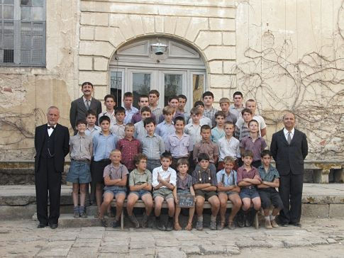 The boys of 'Fond De L'Etang' school. Adults standing (L to R) are Francois Berleand who portrays Rachin, Kad Merad who portrays Chabert and Gerard Jugnot who portrays Clement Mathieu.
