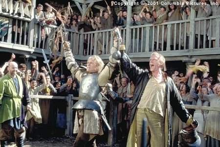 (From left to right) William (Heath Ledger) and Chaucer (Paul Bettany) celebrate one of the young knight's many victories on the tournament field