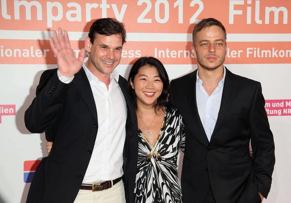 Actors Alexander Beyer and Tom Wlaschiha pose together with producer Yoko Higuchi Zitzmann during a photo call at the Filmparty NRW hosted by Film- und Medienstiftung NRW on June 19, 2012 in Cologne, Germany.