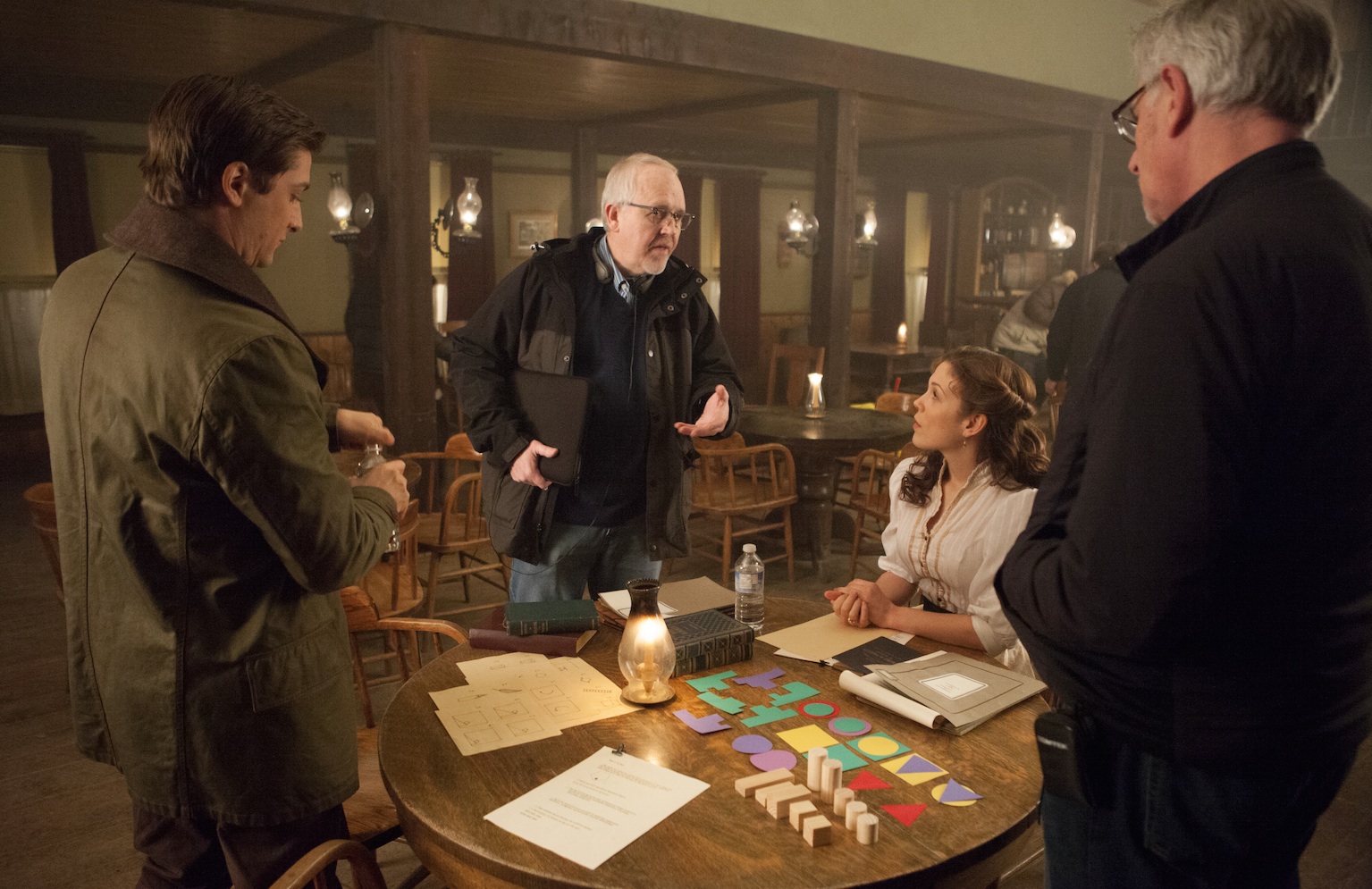 Executive Producer and head writer Brian Bird discussing script with actors Daniel Lissing and Erin Krakow, and director Neill Fearnley