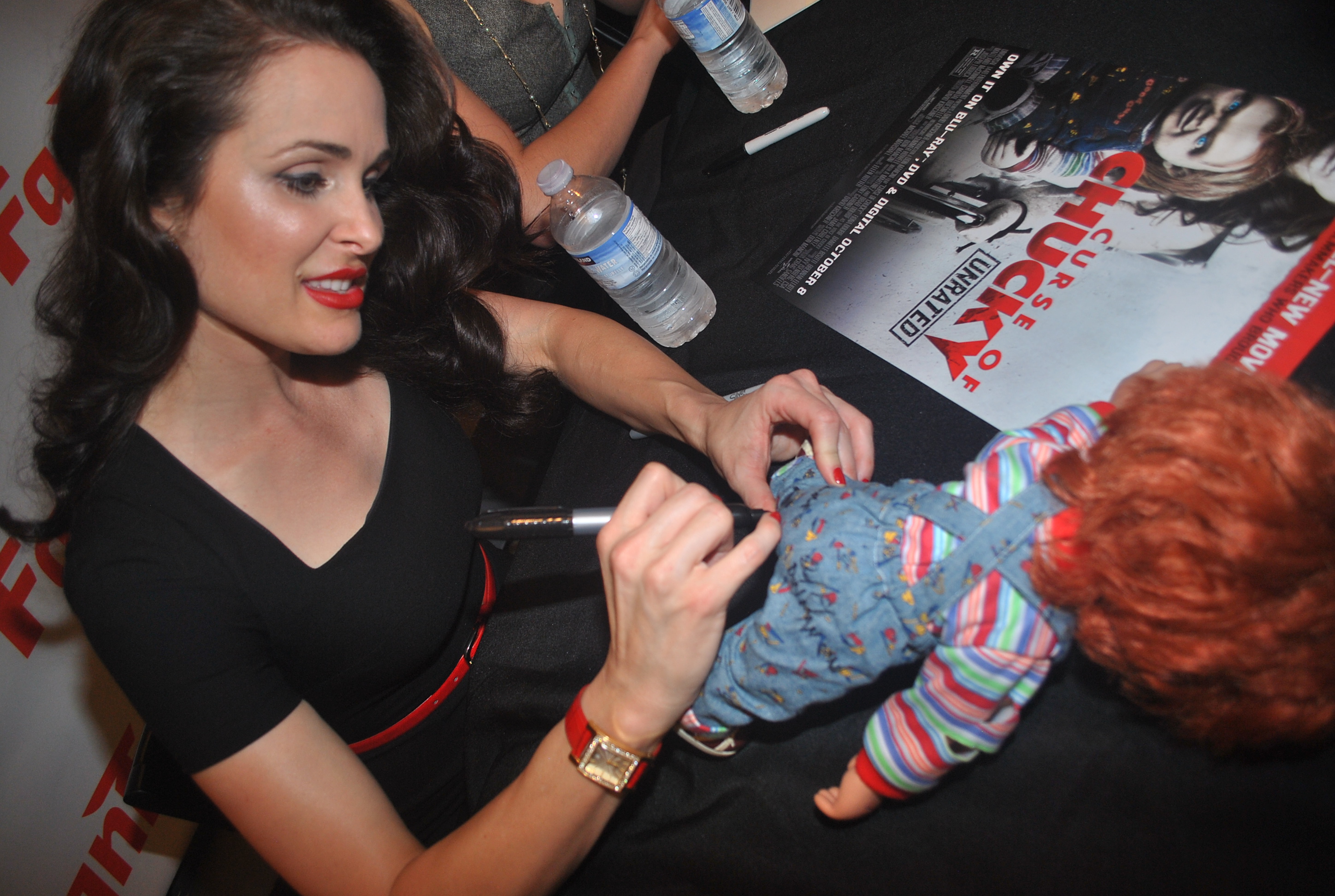 Danielle Bisutti signing a fan's Chucky doll at the 2013 Fantasia Film Festival in Montreal