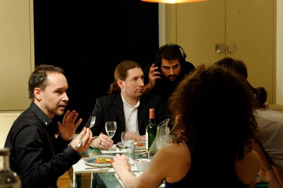 Antony Hickling (right) directs the dinner scene with André Schneider (center) and Manuel Blanc (left) on the set of 