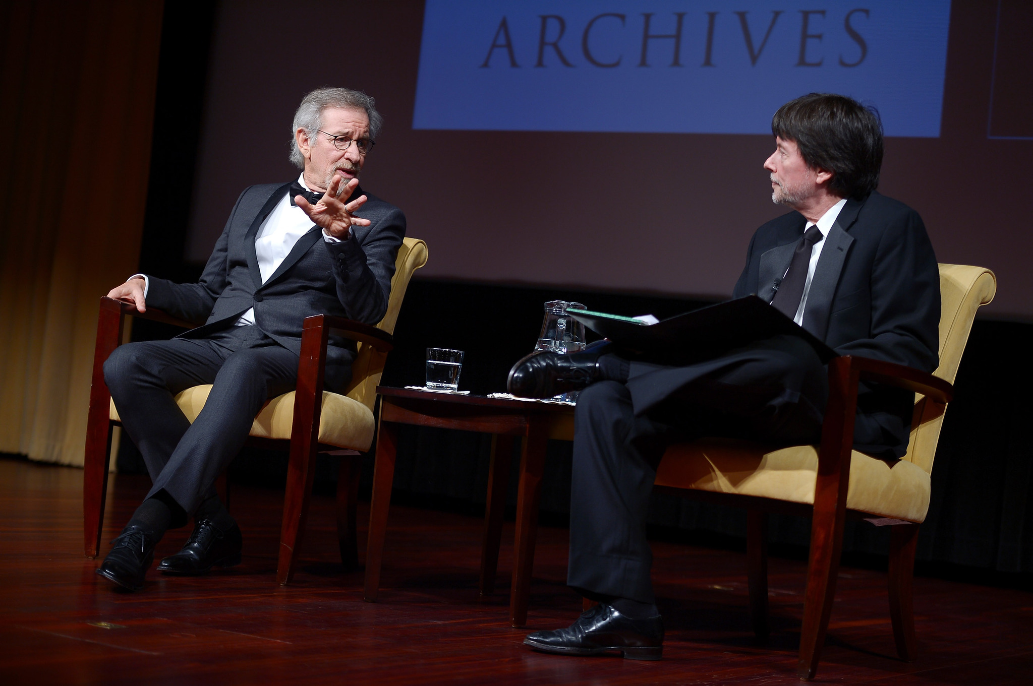 Filmmaker and honoree Steven Spielberg (L) and Foundation for the National Archives Board Vice President and Gala Chair Ken Burns speak onstage at the Foundation for the National Archives 2013 Records of Achievement award ceremony and gala in honor of Steven Spielberg on November 19, 2013 in Washington, D.C.