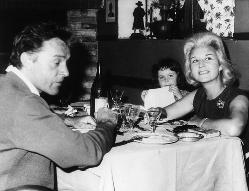 Sybil Burton with Richard and their daughter Kate at a restaurant in Rome