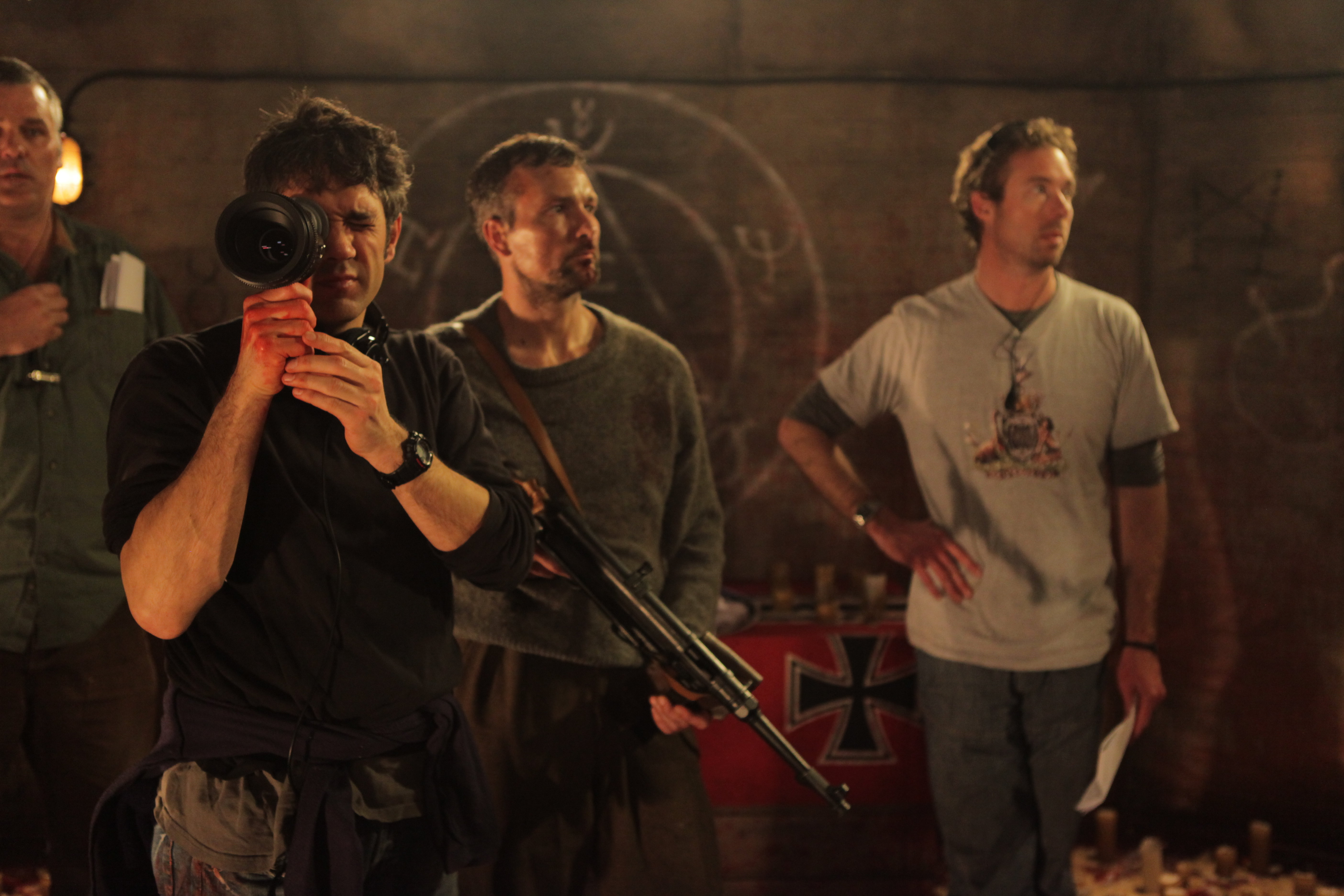 Still of Gaffer Adrian Hebron, Director Paul Campion, Lead Actor Craig Hall, and 1st Assistant Director Richard Matthews on the set of The Devil's Rock