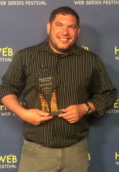 Accepting the BEST CINEMATOGRAPHY award (on befall of Adrian Correia) for SMALL MIRACLES at the 2015 HollyWeb Festival.