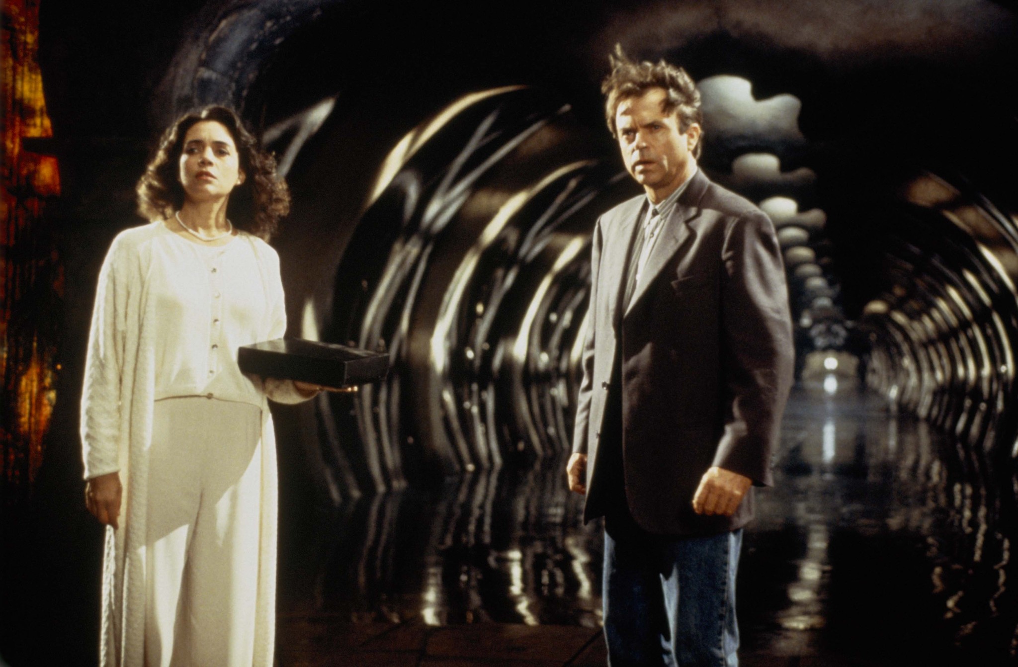 Still of Sam Neill and Julie Carmen in In the Mouth of Madness (1994)