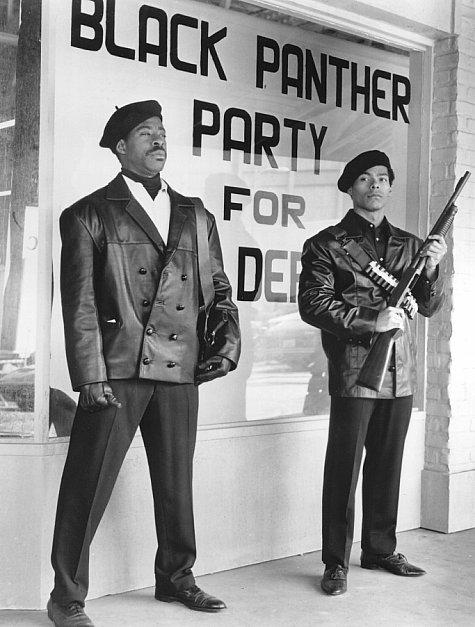 Founding members Bobby Seale (Courtney B. Vance) and Huey Newton (Marcus Chong) keep watch in front of Black Panther headquarters.