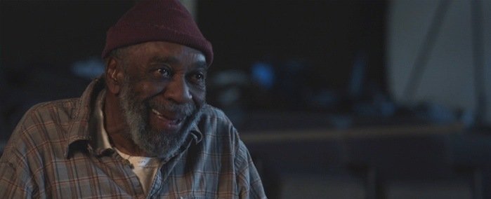 Charlie (Bill Cobbs) listens to the kids sing and dance in the old theater. From 