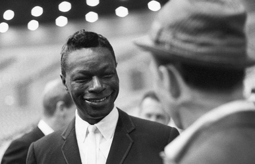 Nat 'King' Cole chatting with Frank Sinatra at an event surrounding the Democratic National Convention