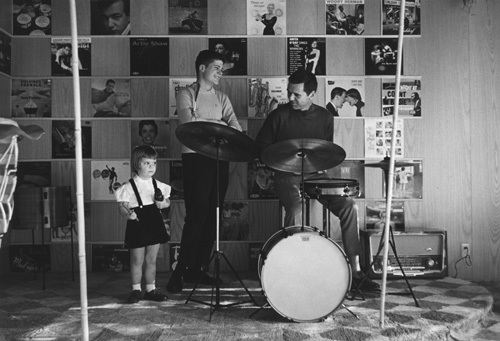 Jackie Cooper playing the drums as daughter Julie and son John Anthony look on