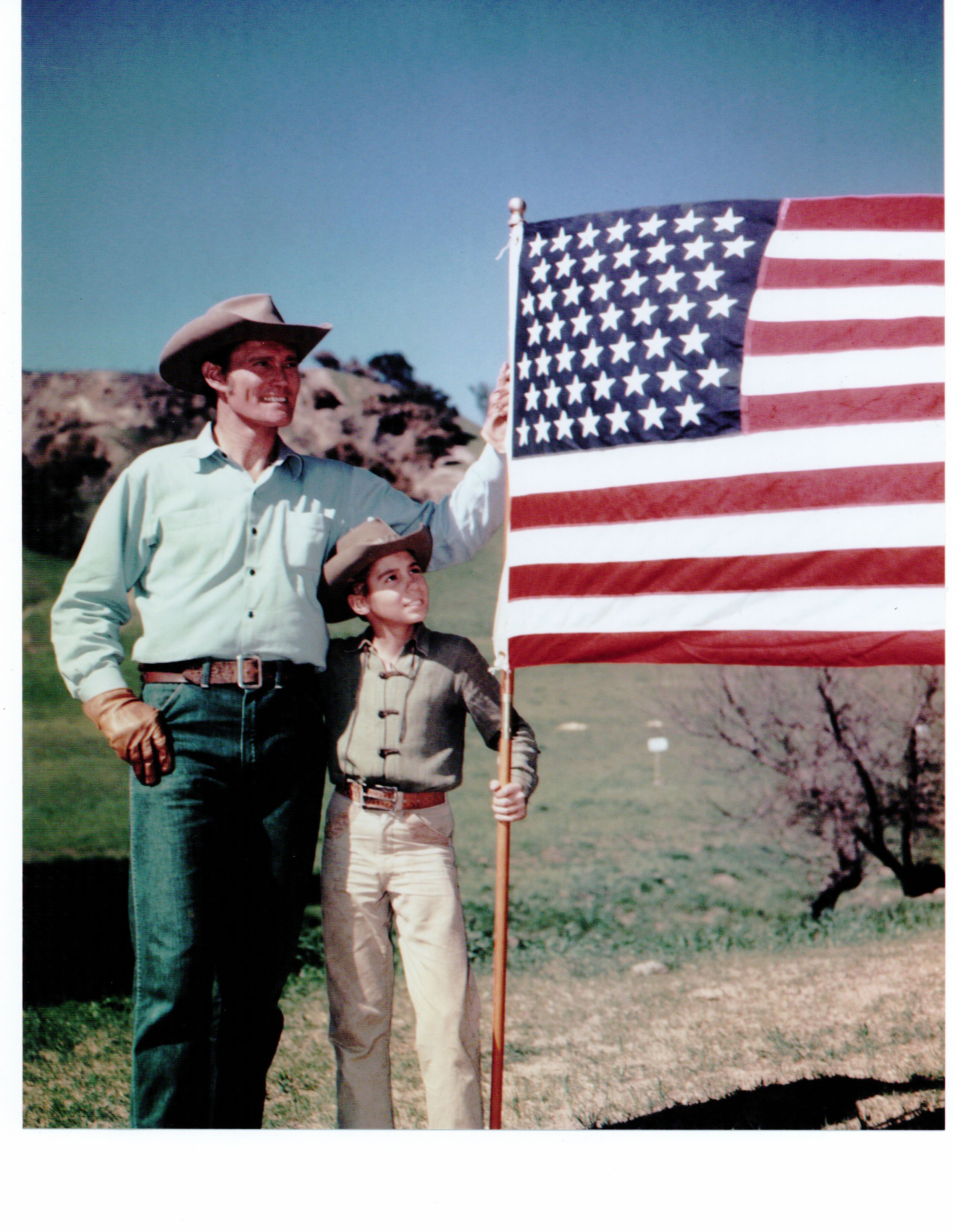 Chuck Connors and Johnny Crawford display the new 49-Star Flag after Alaska was formally granted statehood on January 3, 1959 - stars were arranged in seven rows of seven stars each.