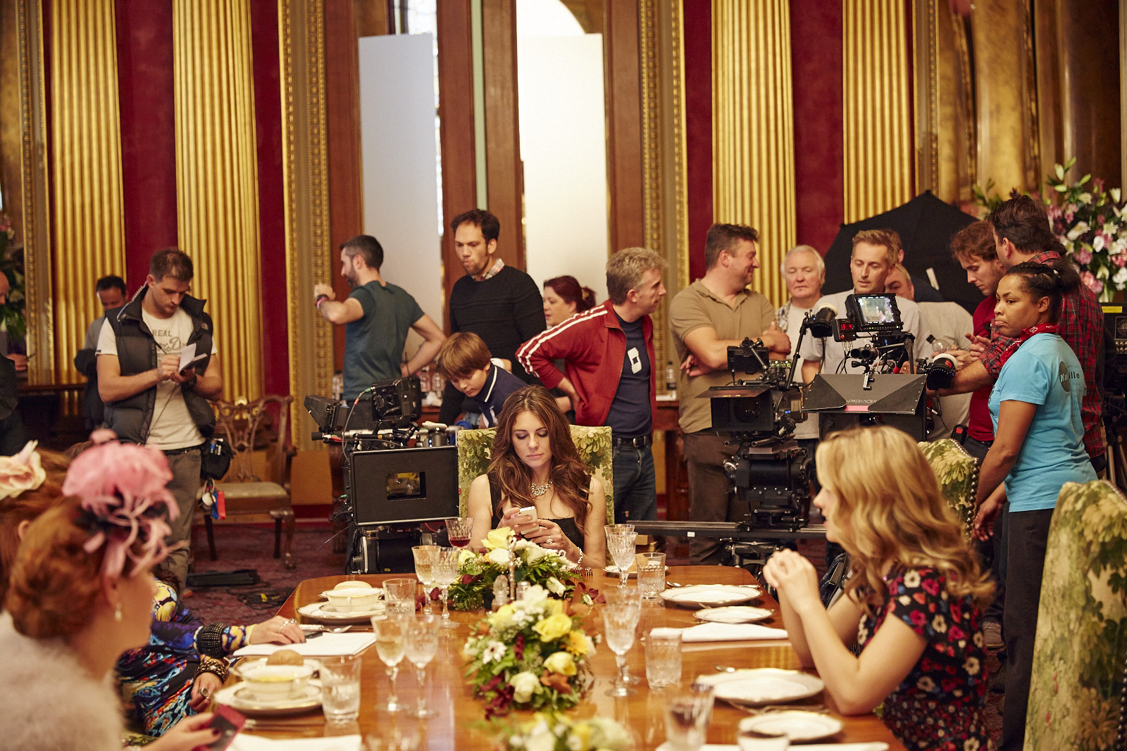 Nick (directly behind camera) on the set of The Royals with Elizabeth Hurley centre