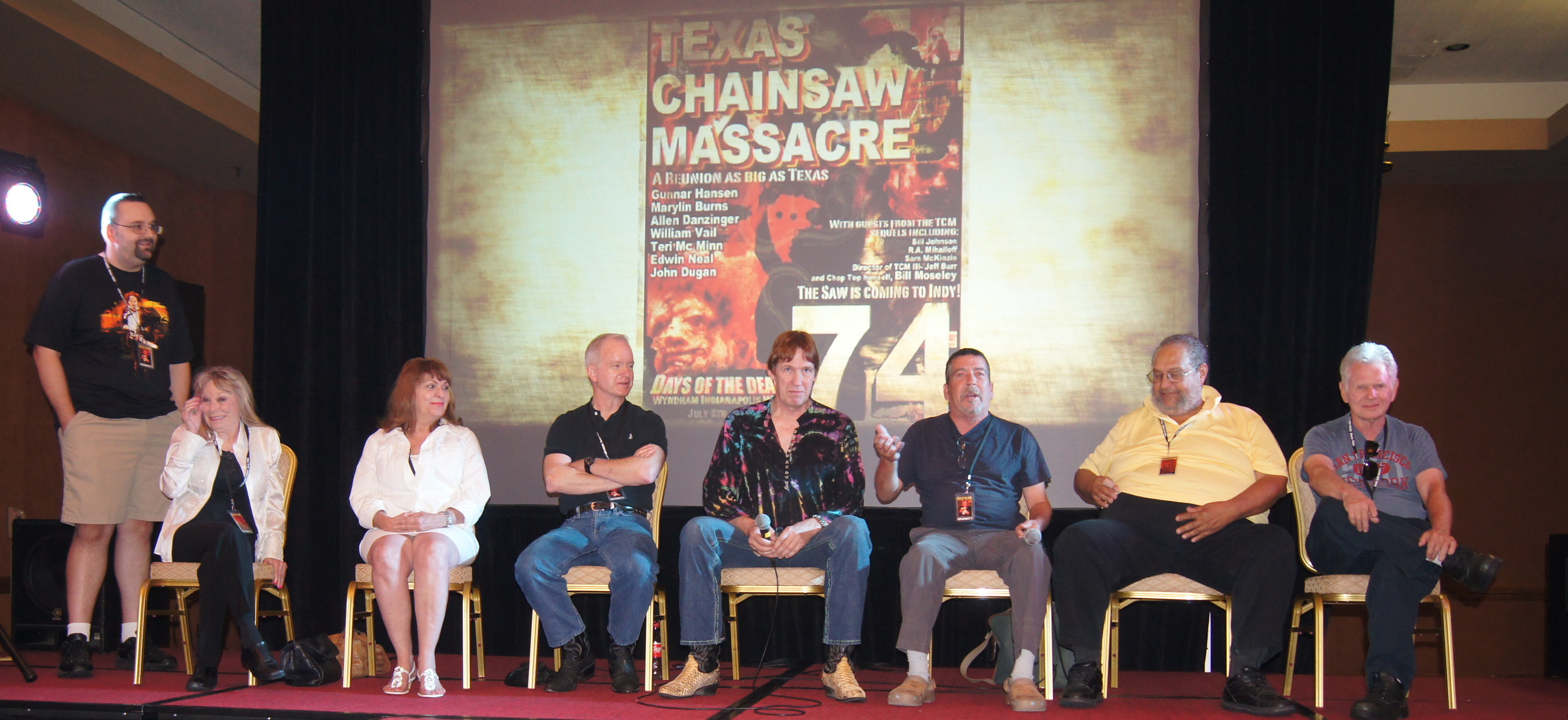 This photo was from the best reunion of The Texas Chain Saw Massacre (1974) at Days of the Dead in USA in 2012. From the left, the emcee Shawn Patrick, (Seated, L-R) ''Sally Hardesty'' Marilyn Burns, ''Pam''Teri McMinn, ''Kirk'' William Vail, ''Grandfather'' John Dugan, ''Hitchhiker'' Ed Neal, ''Cattle Truck Driver'' Ed Guinn, ''Jerry'' Allen Danziger from the TCM panel at Days of the Dead Indianapolis 2012.