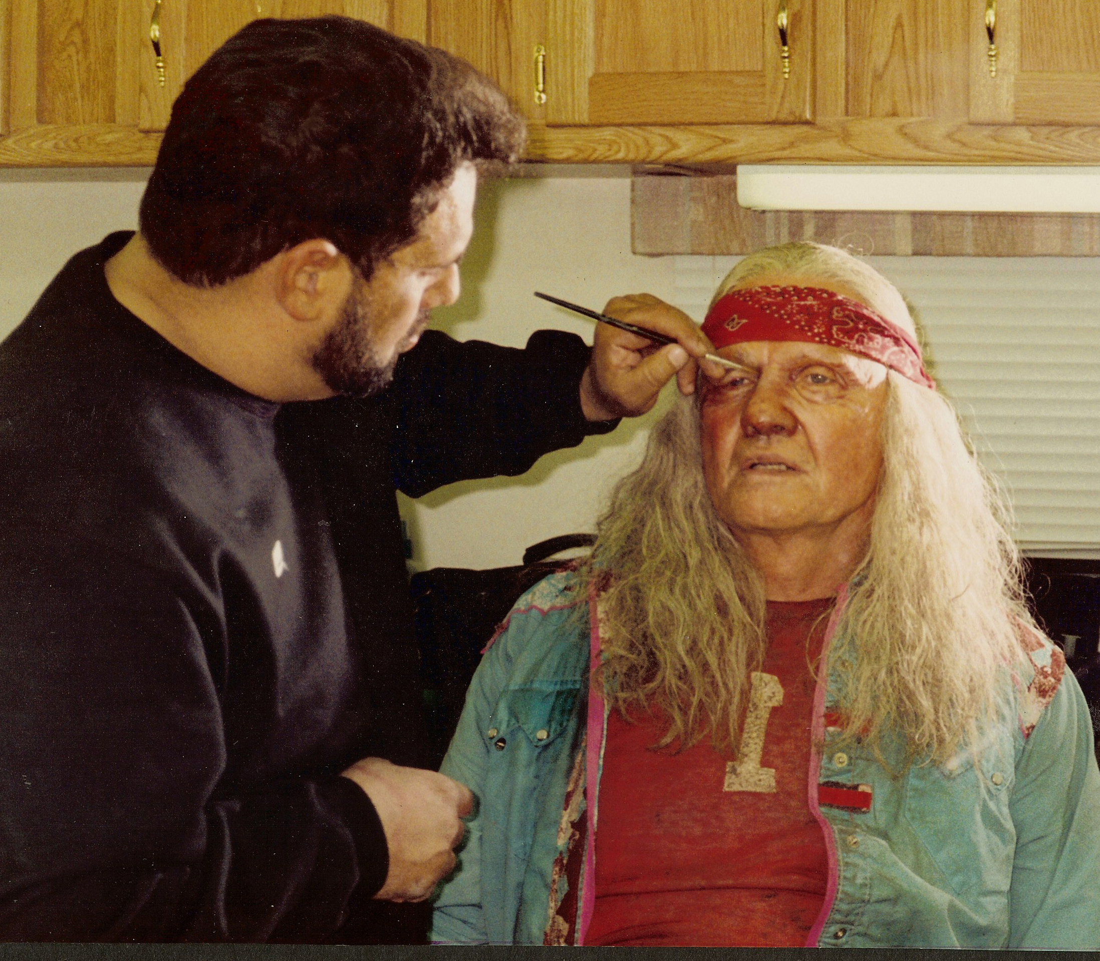 Ken Diaz applying the sun baked, homeless, half breed Native American Shaman makeup, to Jon Voight who is playing the Blind Man in 