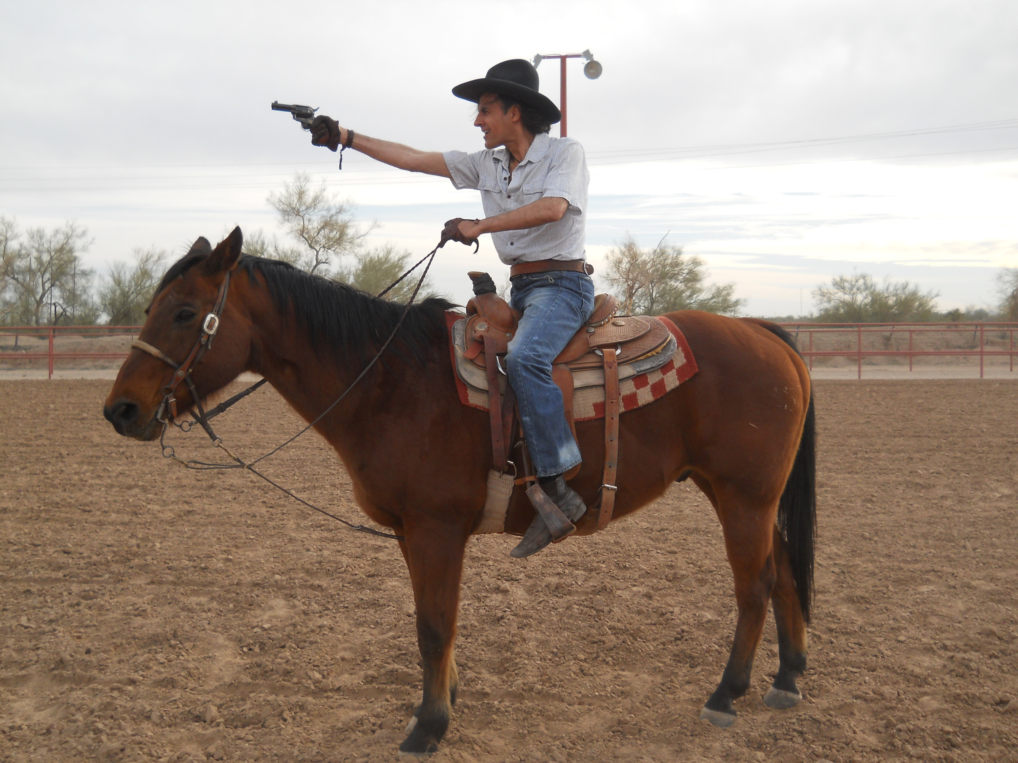 Philippe Durand shooting from a horse on John Wayne's ranch