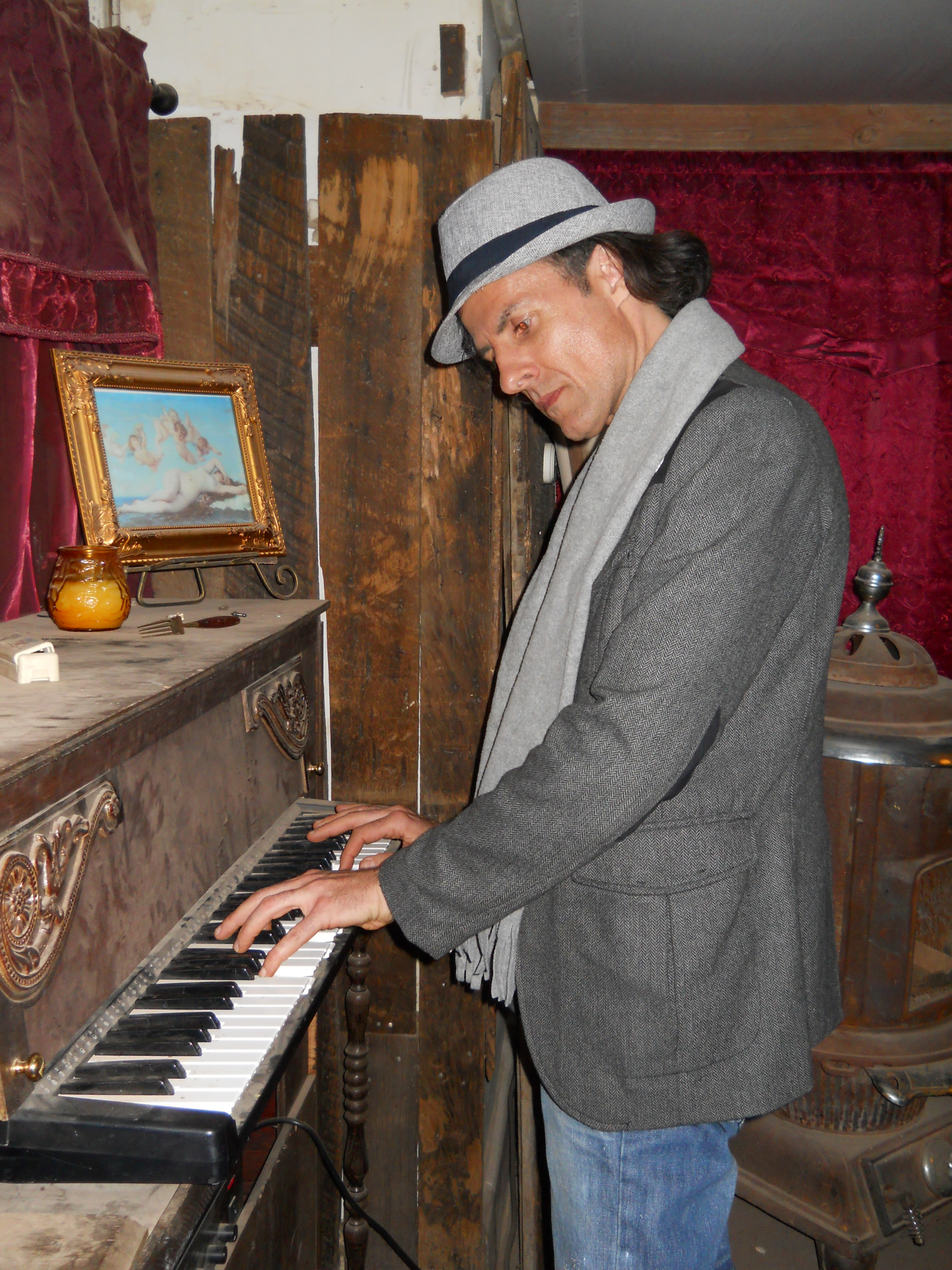 Actor writer director Philippe Durand playing piano in Doc Holliday's poker and faro room