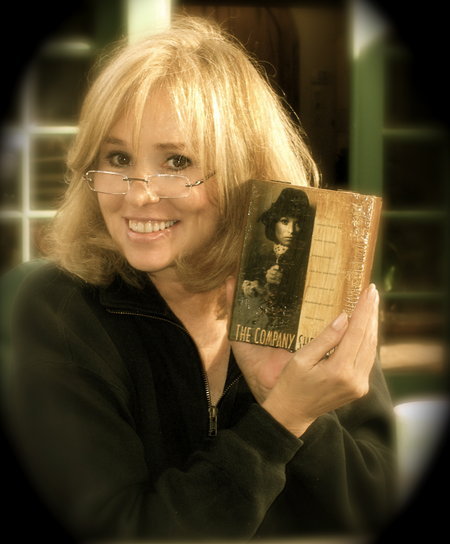 Georgia Durante holding a handmade cigar box made from her book cover 