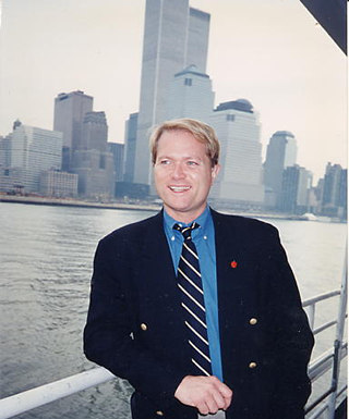 Jim Dykes with twin towers of World Trade Center in background.