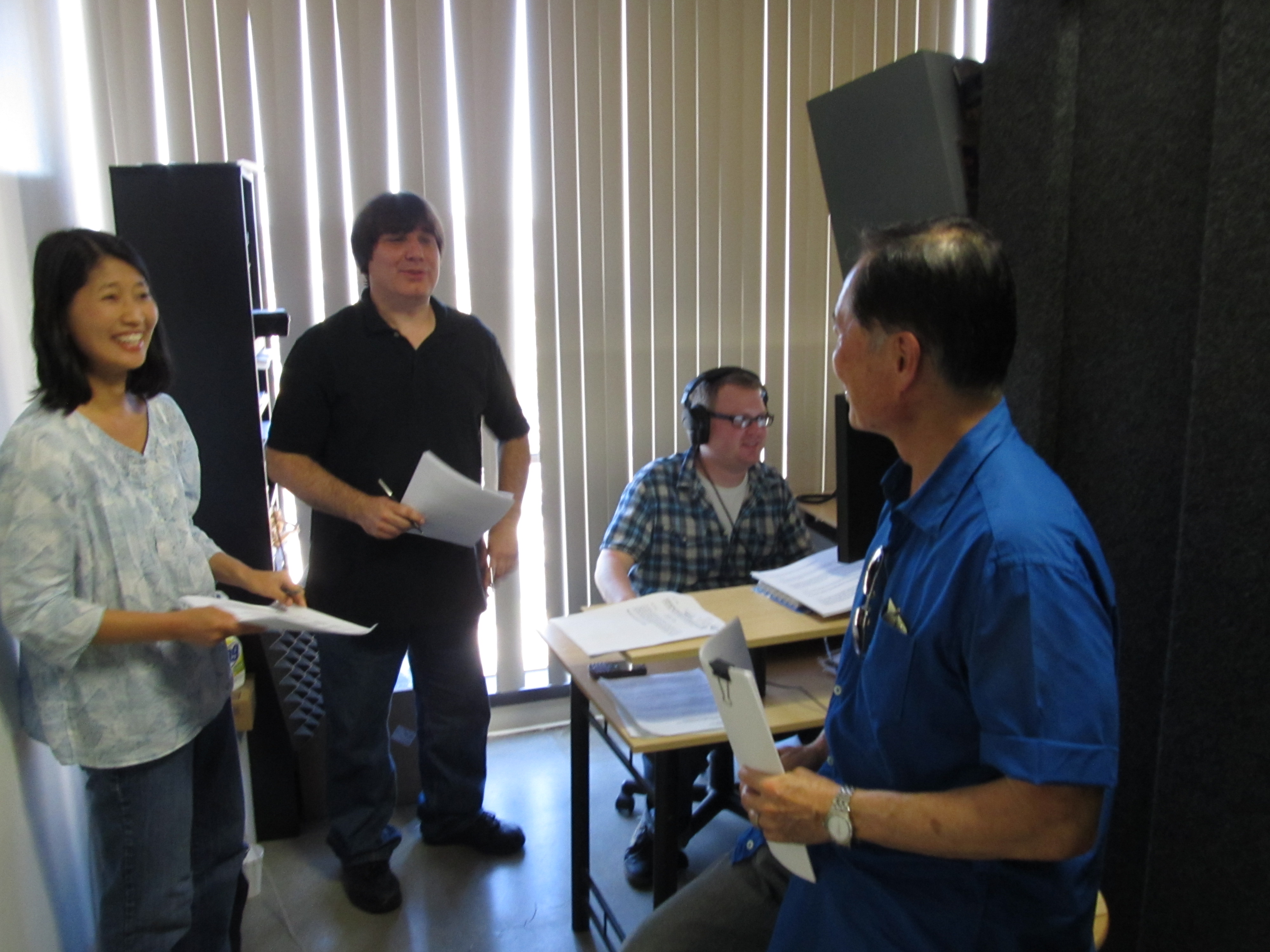 Producer Yuri Senoo and recording director/ co-producer Adam Dykstra, discuss the script with George Takei who narrated the documentary, Message from HiroshimaAn Unrecognized Loss.