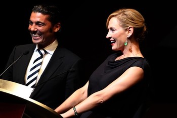 US actress Uma Thurman shares a laugh with Egyptian actor Khaled Nabawy as they present the Black Pearl awards during the closing ceremony of the Abu Dhabi International Film Festival